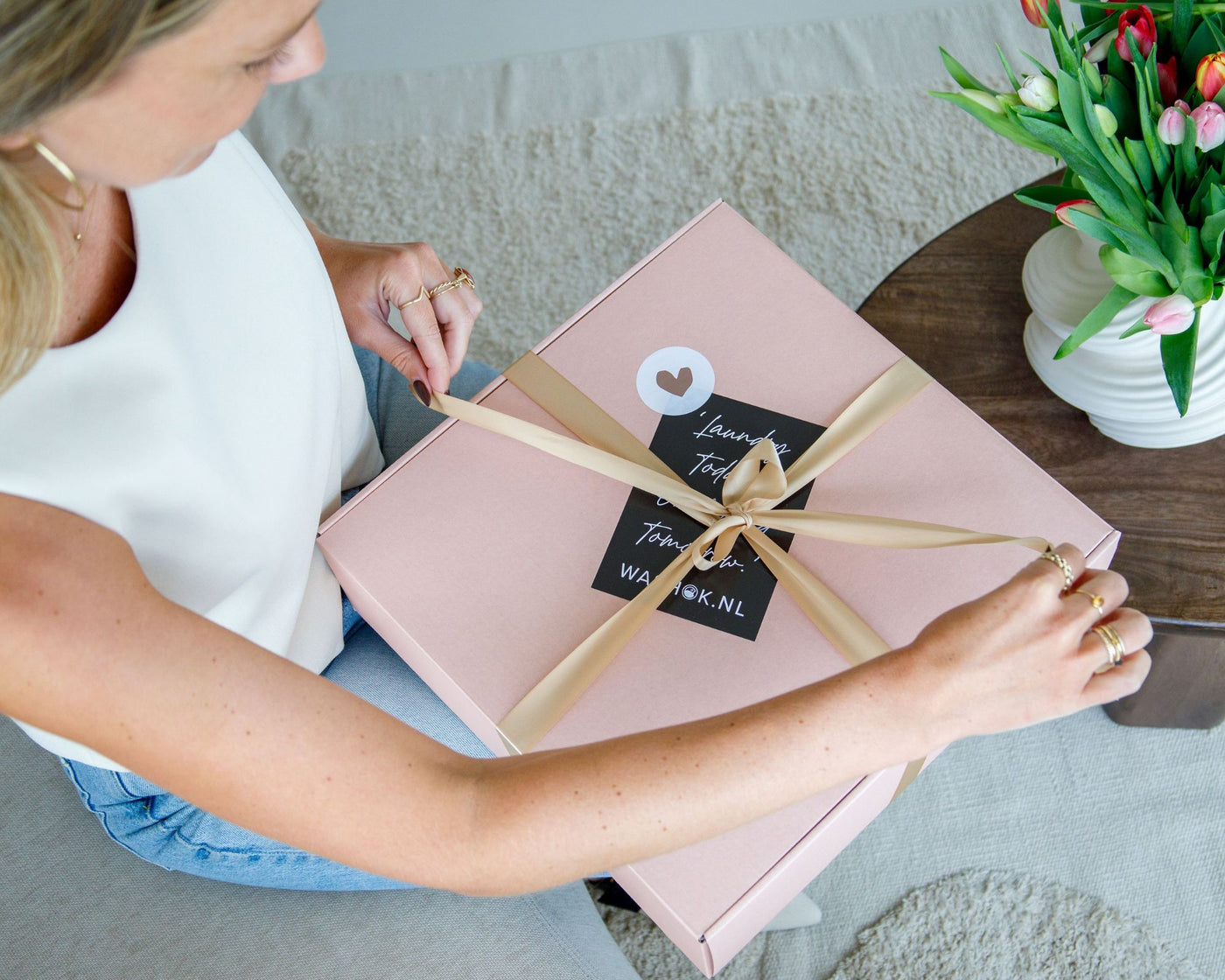 Vrouw die cadeaupakket uitpakt